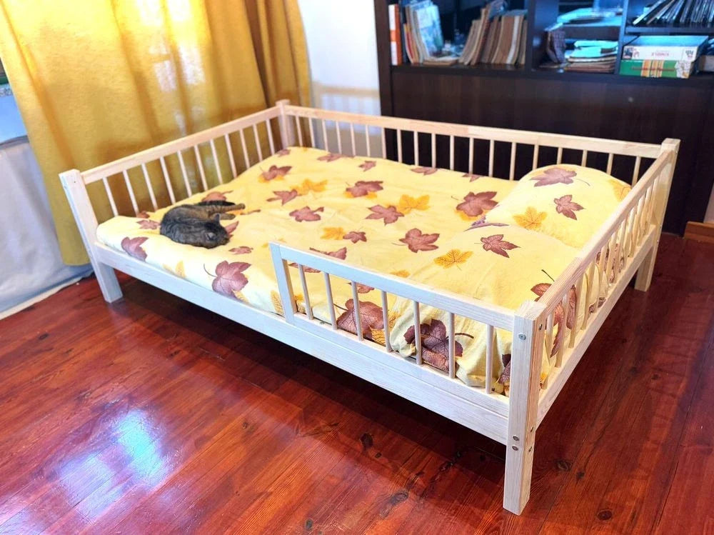 A Snuglee toddler bed with rails fitted on both sides — real product photo, not stock.
