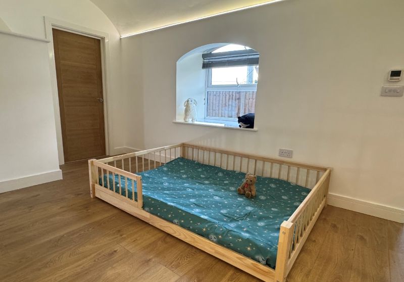 Authentic user photo of Snuglee kids bed with natural pine wood texture