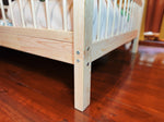 Minimalist toddler bed frame in solid pine wood for modern nursery rooms