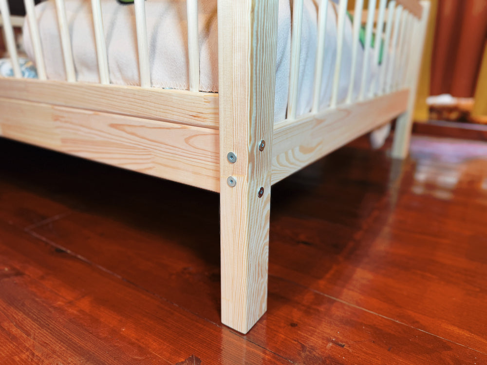 Minimalist toddler bed frame in solid pine wood for modern nursery rooms