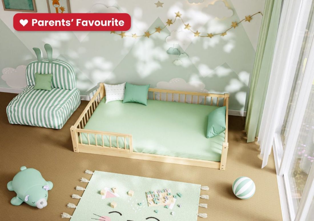Parents’ Favourite: Montessori floor bed in natural solid pine with low side rails in a calm mint green kids’ bedroom