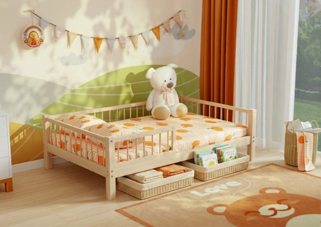 Woven storage baskets with books and blankets under a low rise pine kids’ bed