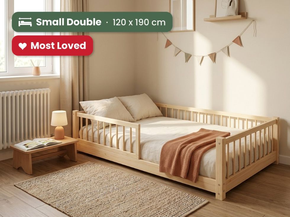 A light natural wood small double bed with safety rails, styled in a warm, sunlit child's bedroom. Most loved by parent